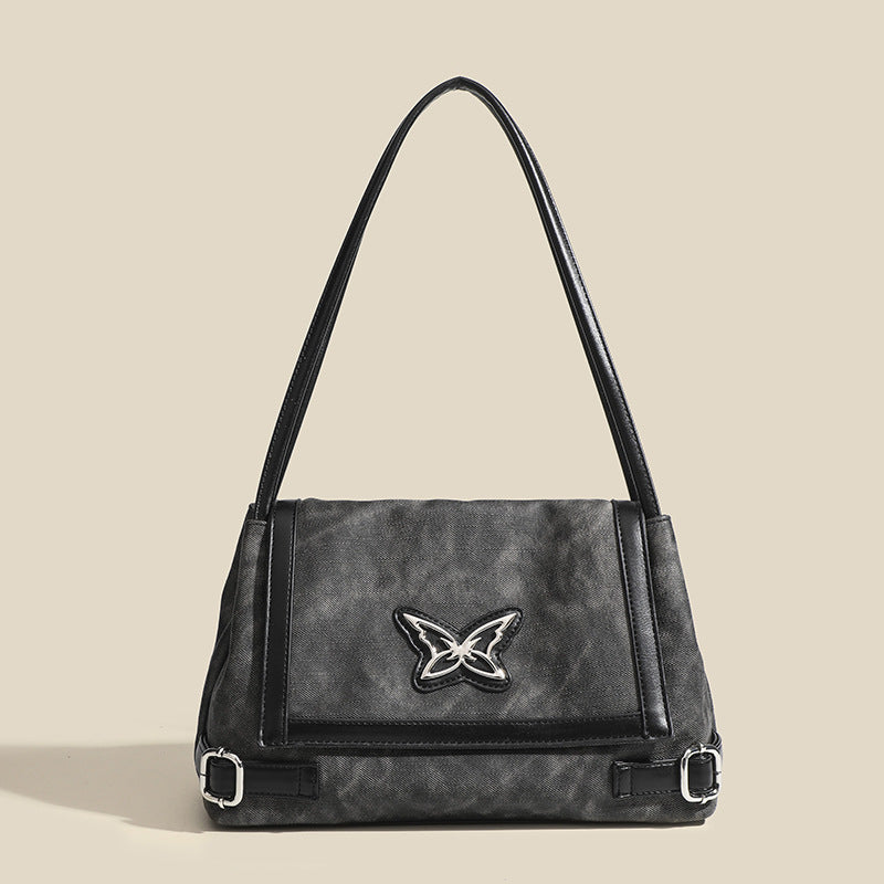 Washed leather-look shoulder tote bag with silver butterfly emblem and buckle hardware, detail view 7