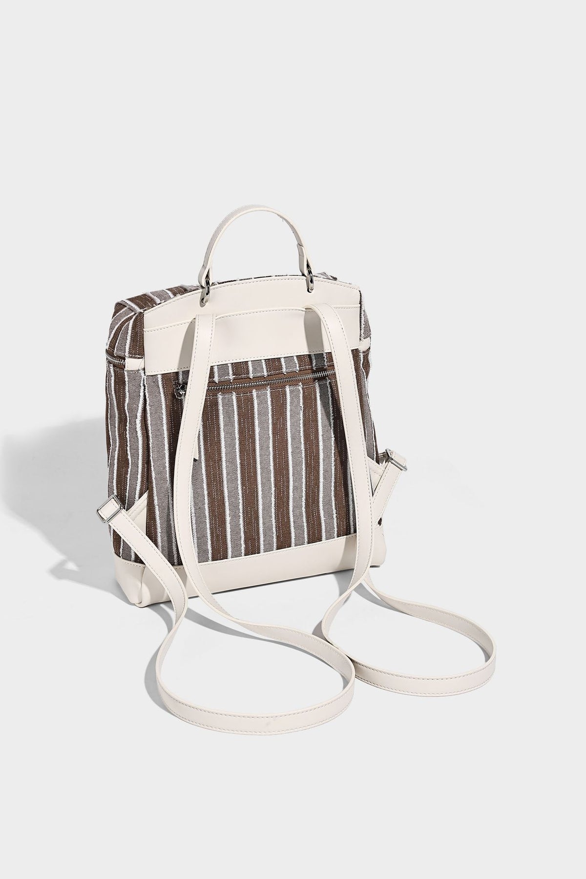 Small structured striped fabric backpack handbag with cream leather-look trim, top handle, and silver-tone hardware, detail