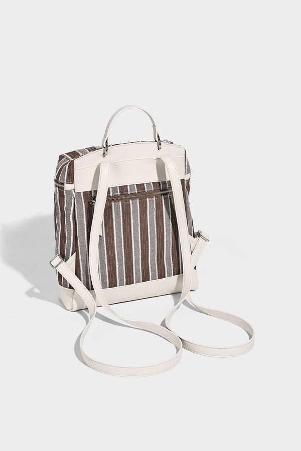 Small structured striped fabric backpack handbag with cream leather-look trim, top handle, and silver-tone hardware, detail