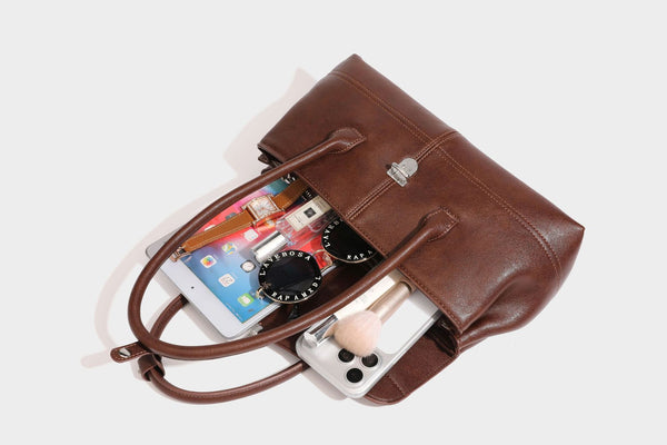 Structured rectangular satchel bag with dual rounded top handles and central metal turn-lock flap closure, detail view 25