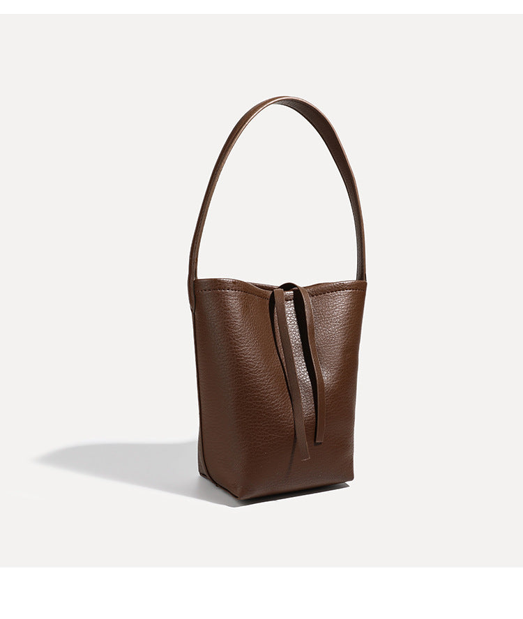 Mini tapered bucket bag in pebbled leather-look finish with front tie straps and single shoulder strap, detail view 20