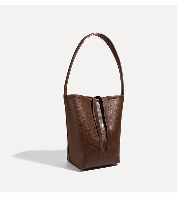 Mini tapered bucket bag in pebbled leather-look finish with front tie straps and single shoulder strap, detail view 20