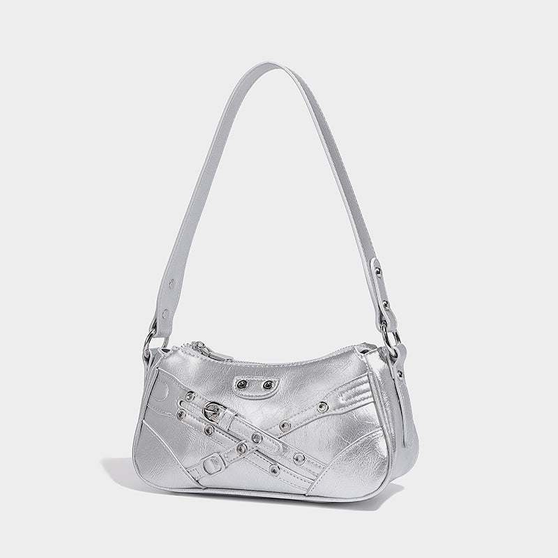 Compact moto-inspired shoulder bag with crisscross grommet strap detail, glossy textured finish, and adjustable crossbody