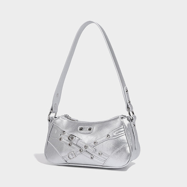 Compact moto-inspired shoulder bag with crisscross grommet strap detail, glossy textured finish, and adjustable crossbody