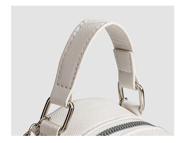 Compact diamond-quilted mini backpack handbag with silver-tone chain straps and turn-lock front pocket, detail view 10
