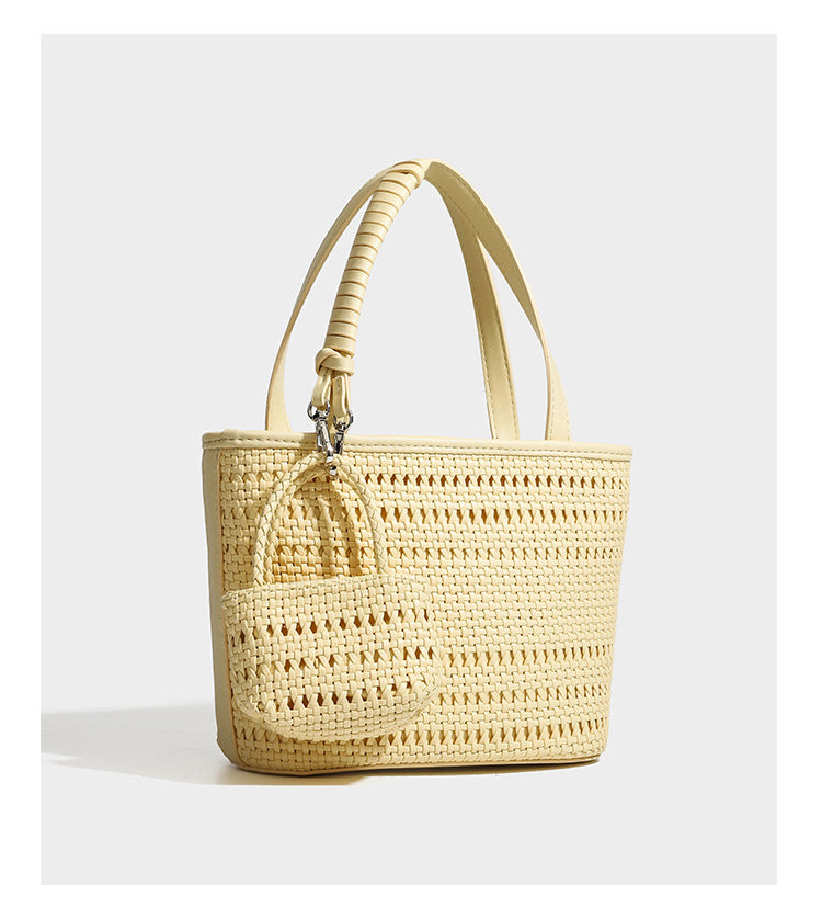 Structured open-weave tote bag with smooth leather-look trim, double top handles, detachable crossbody strap, and mini zip