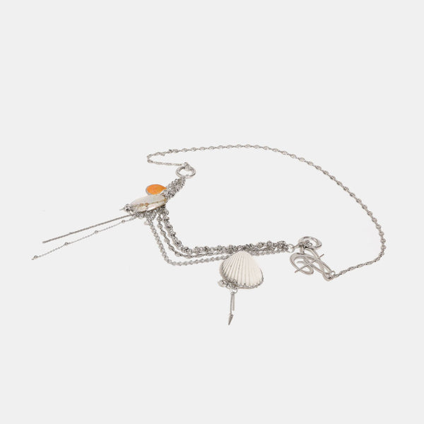 Slouchy lace-overlay bucket bag with silver chain strap, draped chain detail, shell charms, and drawstring top closure