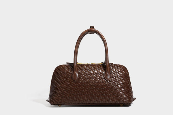 Structured woven-embossed leather-look satchel with dual rolled top handles, gold-tone turn-lock closure, and detachable