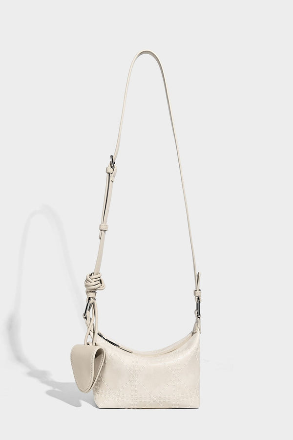 Small embossed half-moon shoulder bag with top zipper, detachable front pouch, and adjustable slim strap, detail view 21