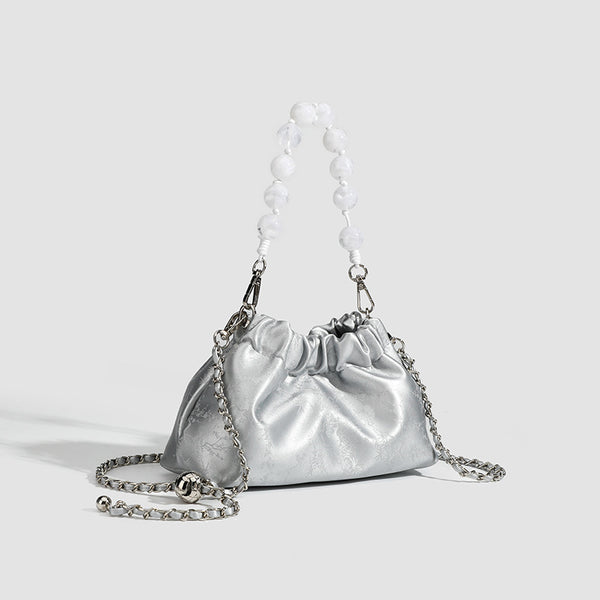 Small ruched drawstring pouch bag with pearl-bead handle and silver-tone chain strap, detail view 3