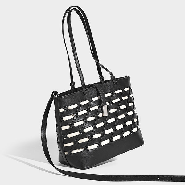 Structured woven lattice cutout tote bag with smooth leather-look trim, dual shoulder straps, and silver-tone hardware, front