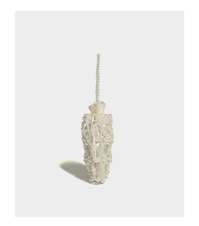 Small pearl-beaded lattice drawstring bucket bag with beaded shoulder strap and ribbon closure, detail view 11