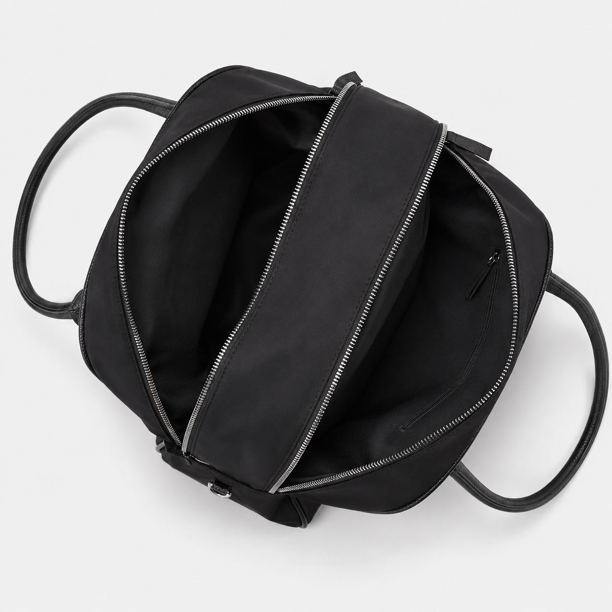 Structured dome top-handle bag in matte nylon with pebbled vegan leather-look trim, zip-top closure, front slip pocket, and
