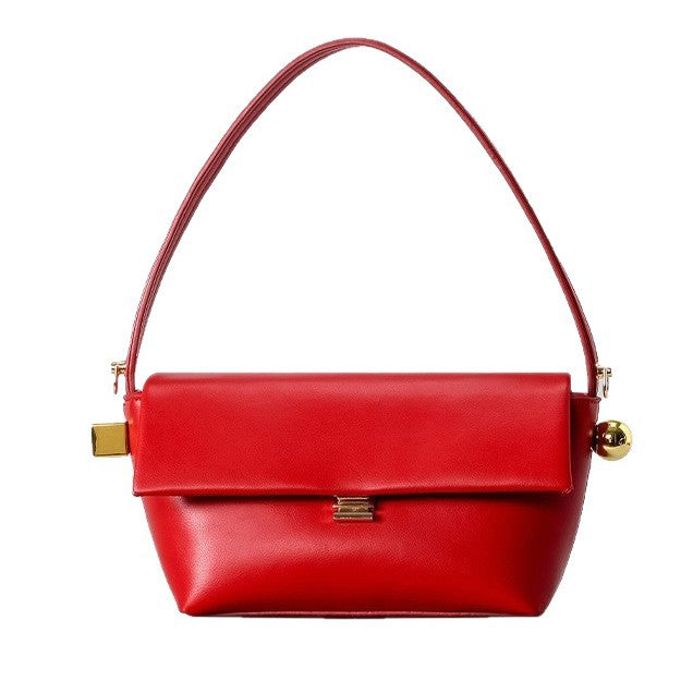 Structured trapezoid flap shoulder bag in red leather-look finish with gold-tone turn-lock clasp, sphere accent, and curved