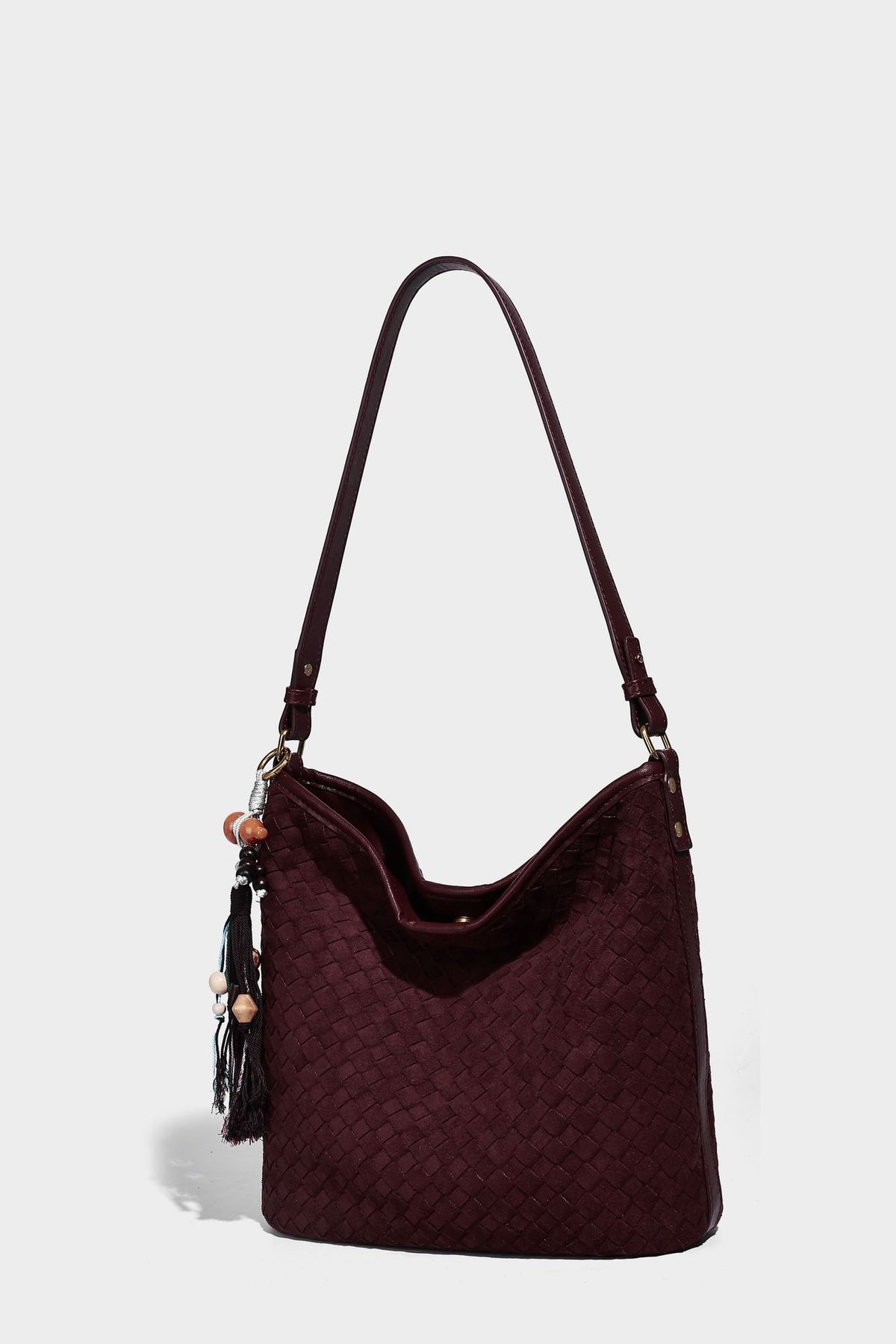 Dark chocolate woven texture hobo shoulder bag with multicolor tassel-and-bead charm and long adjustable strap, detail view