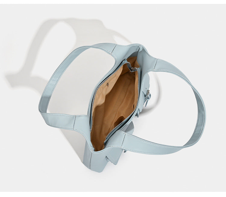 Powder blue structured tote bag with dual front flap buckle pockets and silver-tone hardware, detail view 7