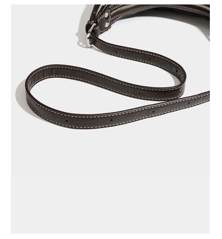 Slouchy hobo shoulder bag in glossy crinkled leather-look finish with zip-top closure and silver-tone ring hardware, detail