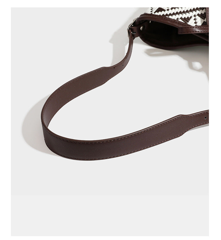 Woven geometric bucket shoulder bag in white and dark brown two-tone pattern with leather-look trim and drawstring top