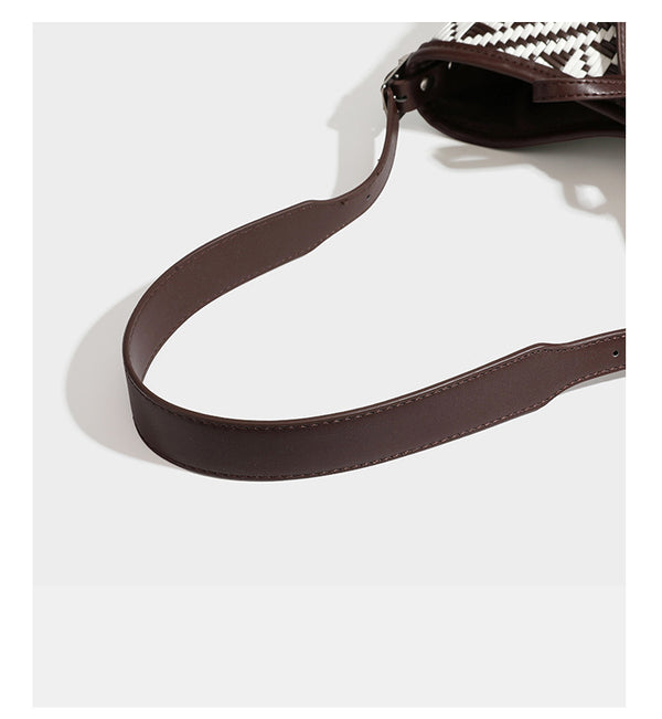 Woven geometric bucket shoulder bag in white and dark brown two-tone pattern with leather-look trim and drawstring top