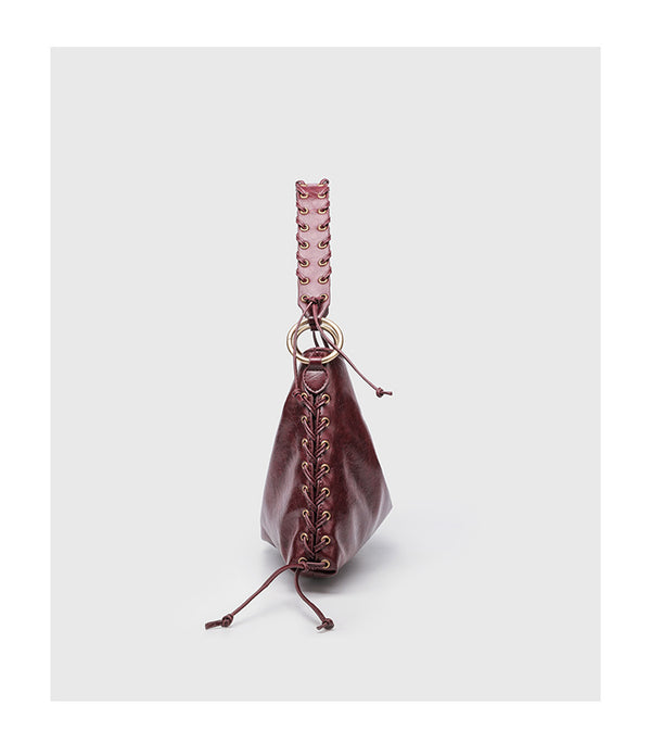 Large slouchy hobo shoulder bag with braided top handle, gold-tone O-ring hardware, and lace-up side cord detailing in