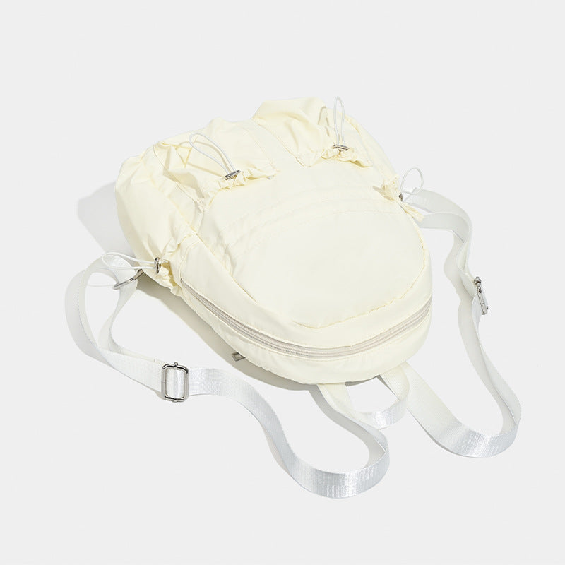 Puffy matte nylon mini backpack with drawcord gathered front pockets and silver-tone hardware, detail view 4