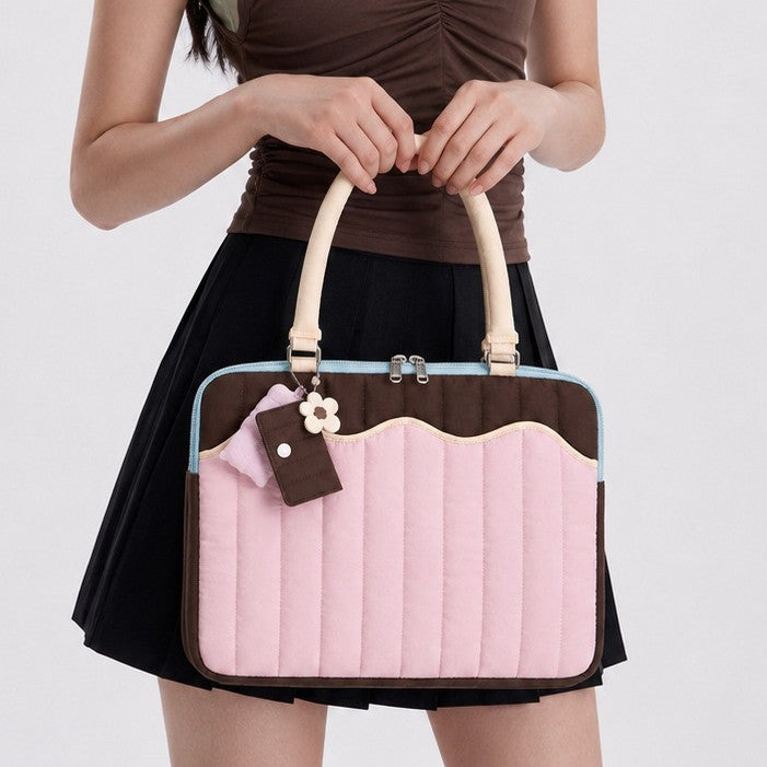 Quilted colorblock handbag with wavy scalloped front panel, padded arched top handles, and dual zip closure, detail view 2