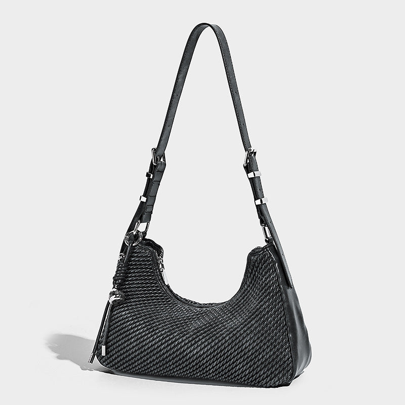 Woven crescent hobo shoulder bag with smooth side panels, zip-top closure, silver-tone charm hardware, and adjustable, detail