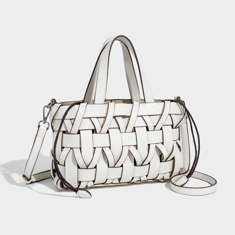 Structured woven basket tote handbag with contrasting dark trim, double top handles, detachable shoulder strap, and