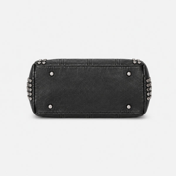 Black leather-look satchel bag with gunmetal rivet trim, grid-stitched paneling, dual rolled top handles, and curved zip