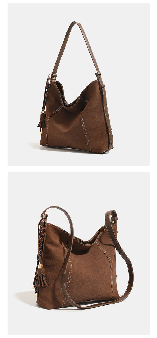 Slouchy suede-finish hobo shoulder bag in warm mocha brown with contrast stitching, braided tassel side accent, and, detail