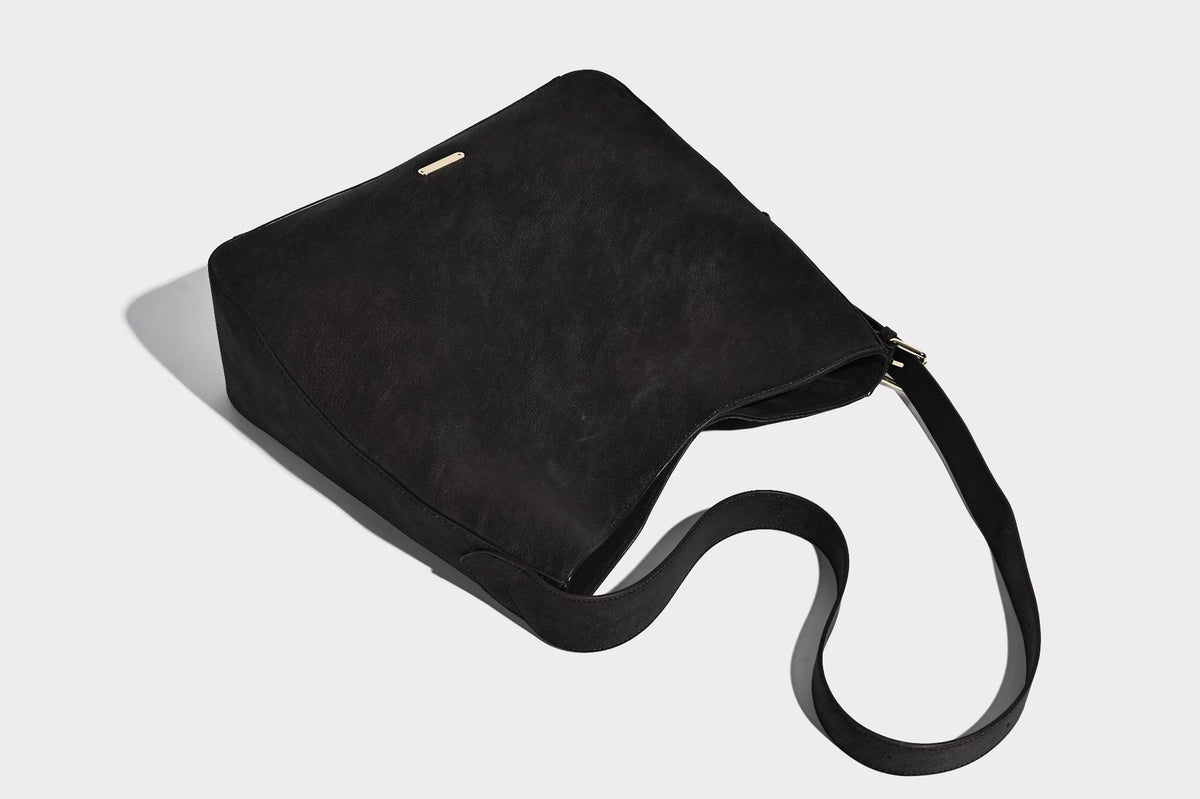 Large slouchy hobo shoulder bag in matte leather-look finish with adjustable strap and gold-tone bar hardware, detail view 27