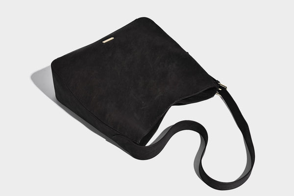 Large slouchy hobo shoulder bag in matte leather-look finish with adjustable strap and gold-tone bar hardware, detail view 27