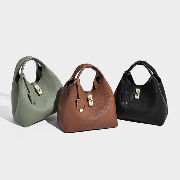 Structured pebbled-texture bucket bag with arched top handles, gold-tone turn-lock closure, and detachable shoulder strap