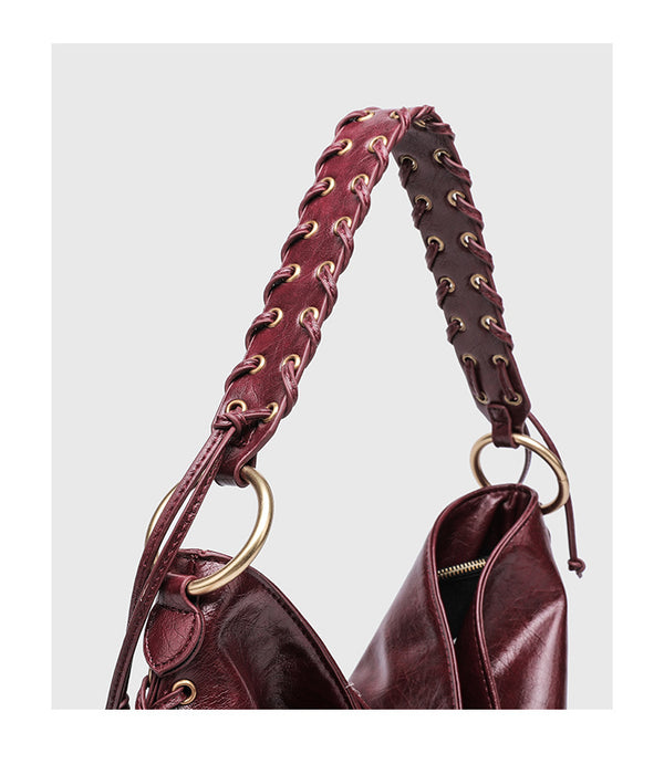 Large slouchy hobo shoulder bag with braided top handle, gold-tone O-ring hardware, and lace-up side cord detailing in