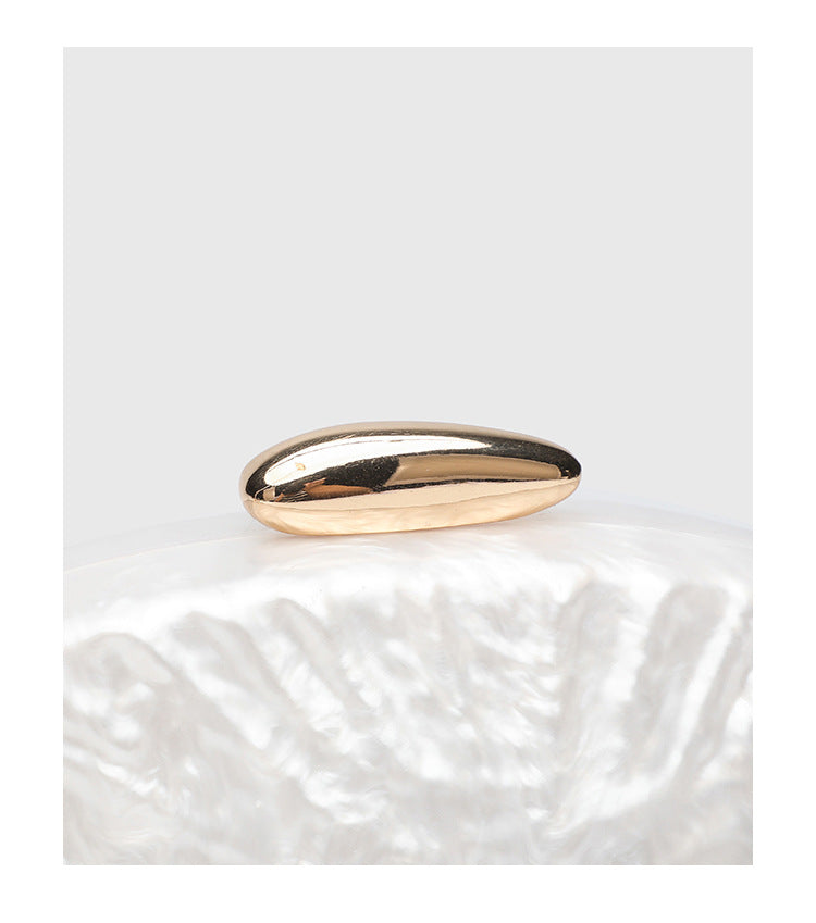 Oval pearl-finish shell clutch bag with gold-tone clasp and removable gold link chain strap, detail view 12