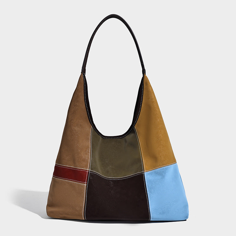 Multicolor patchwork hobo shoulder bag with brown tan olive mustard red and blue suede-look panels, contrast white stitching