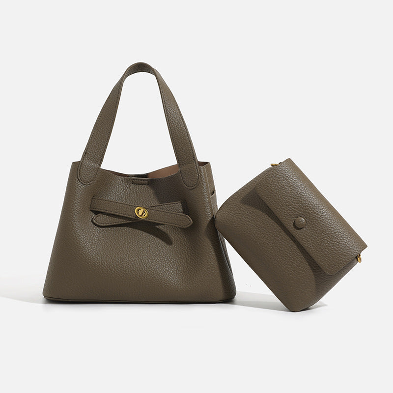 Pebbled trapezoid tote bag with gold turn-lock strap detail and matching snap pouch, detail view 4