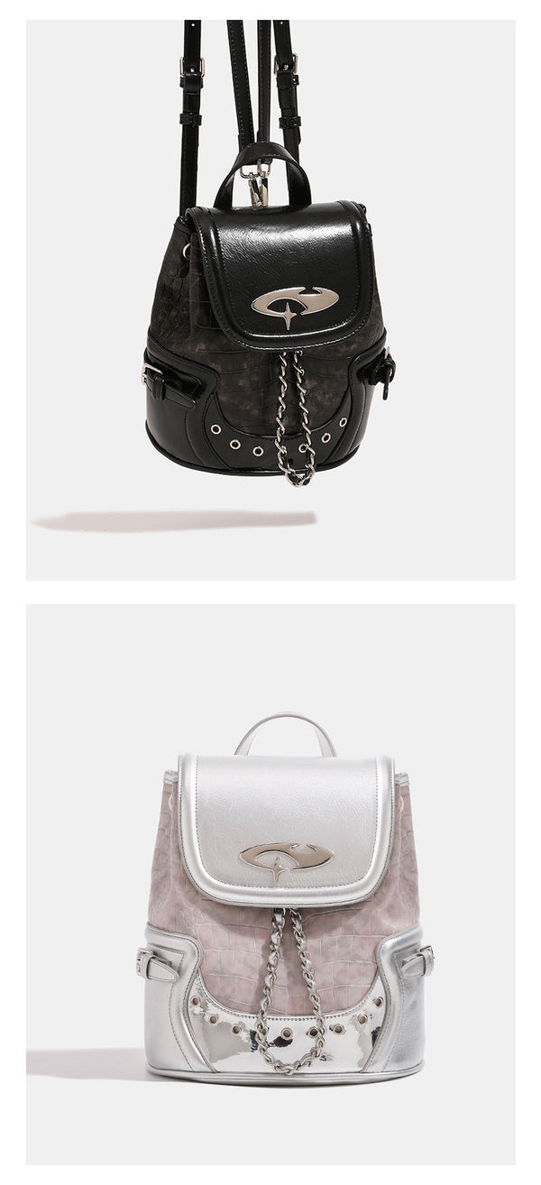 Croc-embossed mini backpack handbag with metallic silver flap, turn-lock closure, chain front detail, and top handle, detail