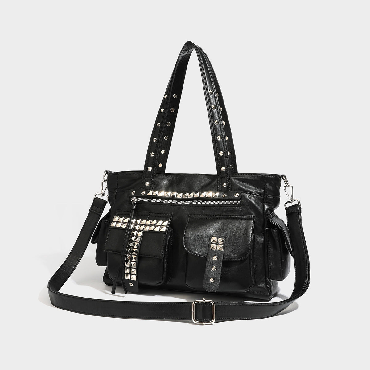 Black leather-look tote bag with silver pyramid studs on handles and front panel, multiple flap and zip exterior pockets