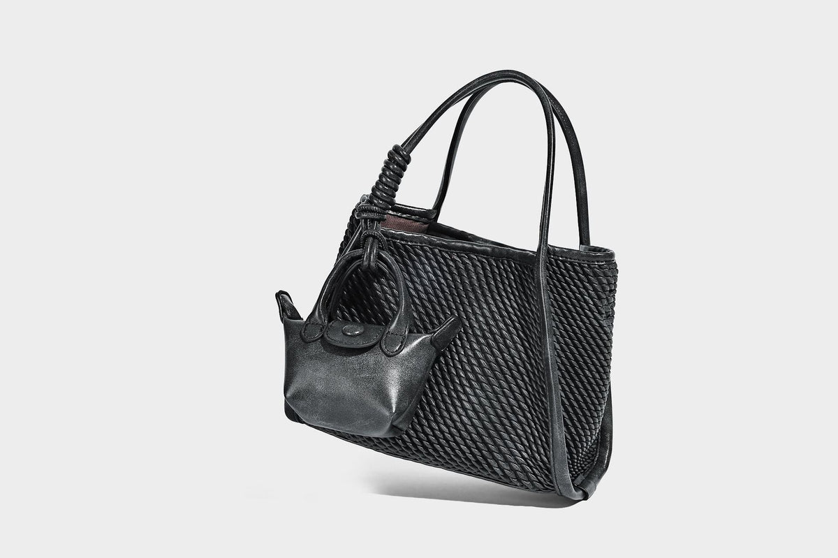 Large structured woven rope-texture tote bag with smooth leather-look trim, knotted dual top handles, detachable mini front