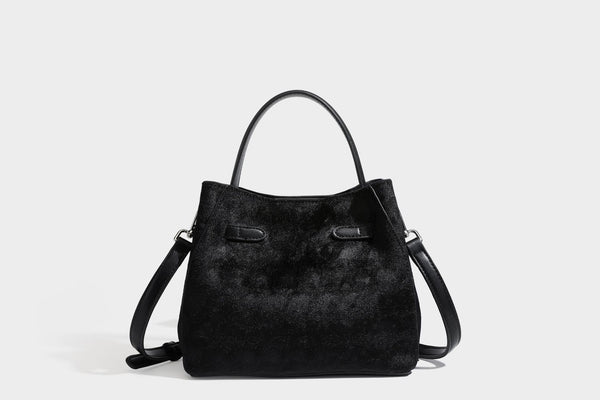 Small structured bucket satchel in embossed velvet-texture fabric with silver turn-lock hardware, rounded top handle, and