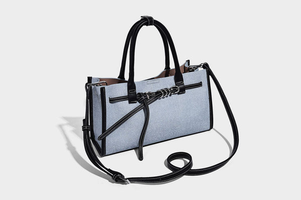 Structured rectangular tote satchel in denim-look fabric with dark trim, knotted front strap hardware, and detachable, detail