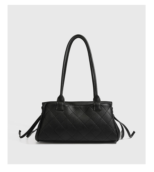 Structured black diamond-quilted shoulder bag with gold-tone turn-lock flap closure and dual round shoulder straps, detail