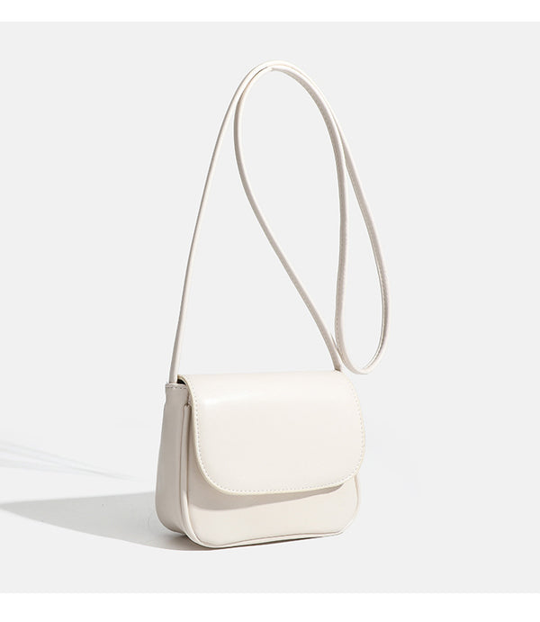 Compact rounded rectangular flap crossbody bag with glossy leather-look finish and long shoulder strap, detail view 17