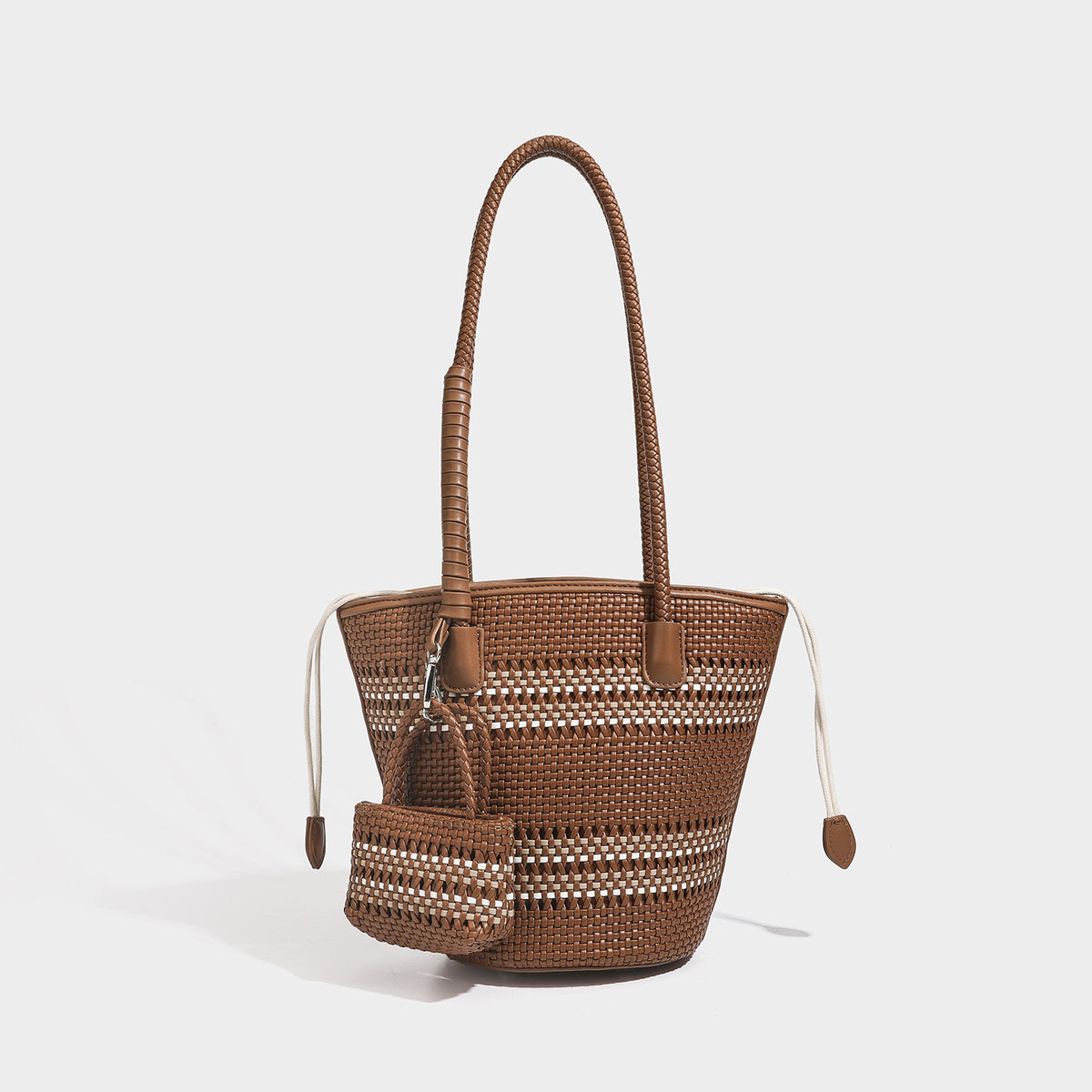Structured woven bucket tote bag in pastel blue with braided shoulder strap, open lattice weave body, cream drawstring