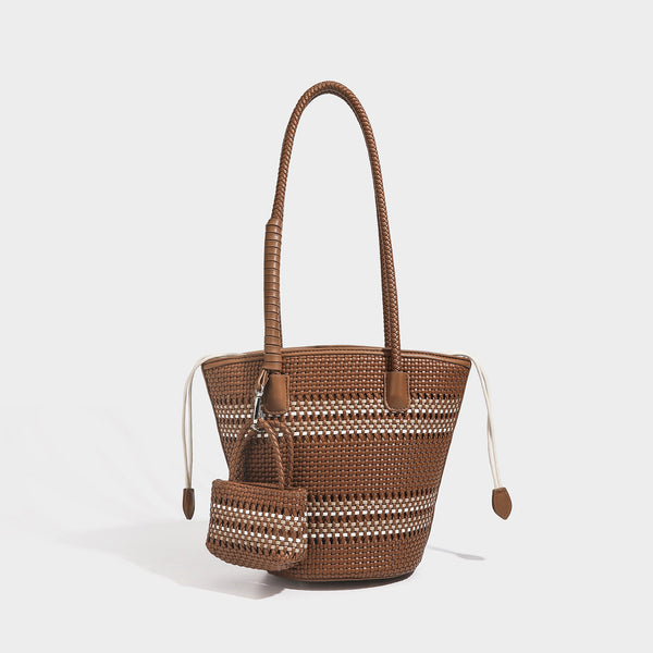 Structured woven bucket tote bag in pastel blue with braided shoulder strap, open lattice weave body, cream drawstring