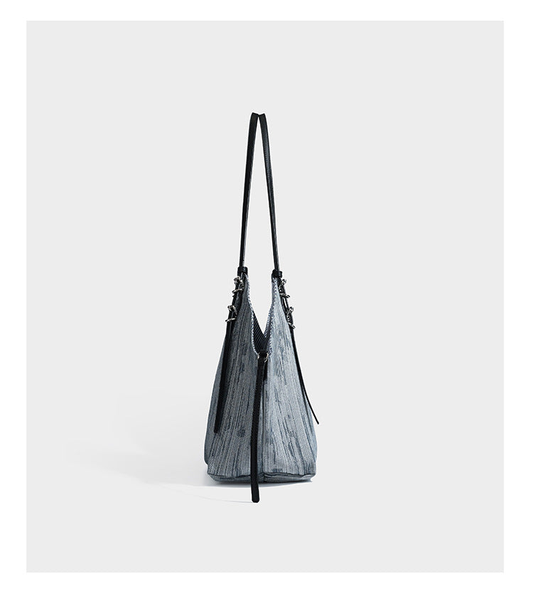 Large slouchy woven-texture shoulder tote bag with slim leather-look straps, side cinch ties, and silver-tone hardware