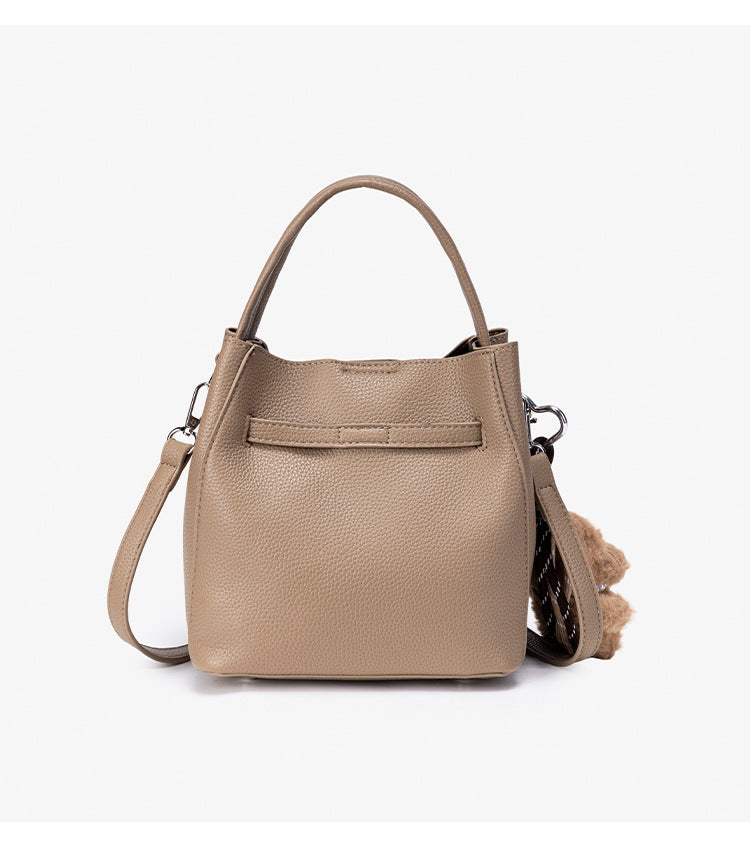 Compact structured bucket bag in pebbled leather-look finish with silver turn-lock front clasp, dual top handles, detachable