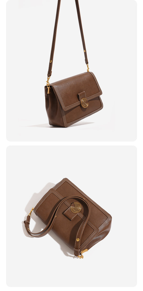 Structured flap shoulder bag with gold-tone circular turn-lock closure, white contrast stitching, and adjustable strap