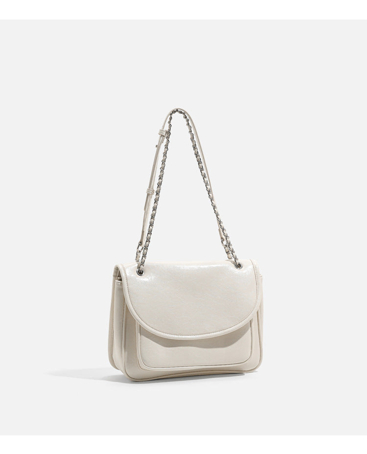 Structured glossy leather-look flap crossbody satchel with woven chain-and-leather shoulder strap, detail view 16